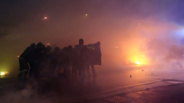 Demonstrators clash with police during a protest against the Milan-Cortina 2026 Olympics, in Milan, Italy,