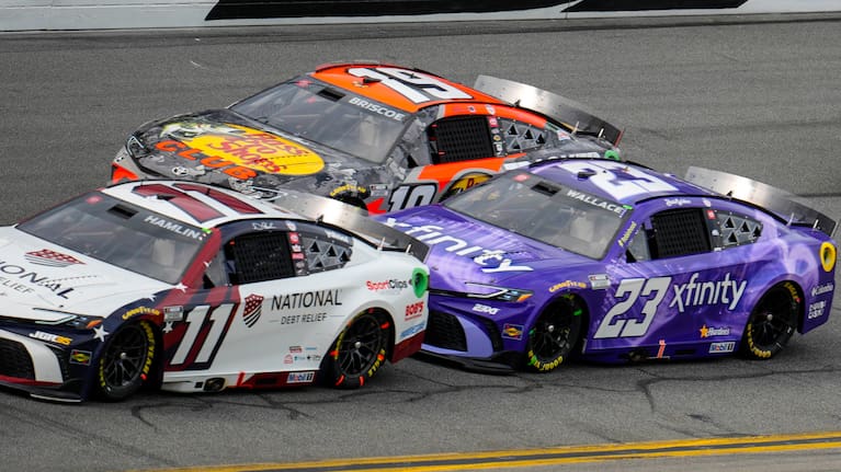 Denny Hamlin, (11), Bubba Wallace, (23) and Chase Briscoe, (19) run during the NASCAR Daytona 500 auto race at Daytona International Speedway