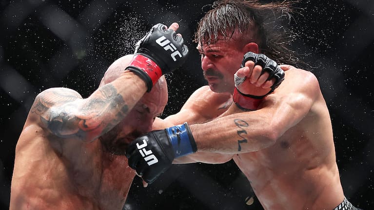Diego Lopes of Brazil and Alexander Volkanovski of Australia fight in the featherweight title bout during the UFC 325.