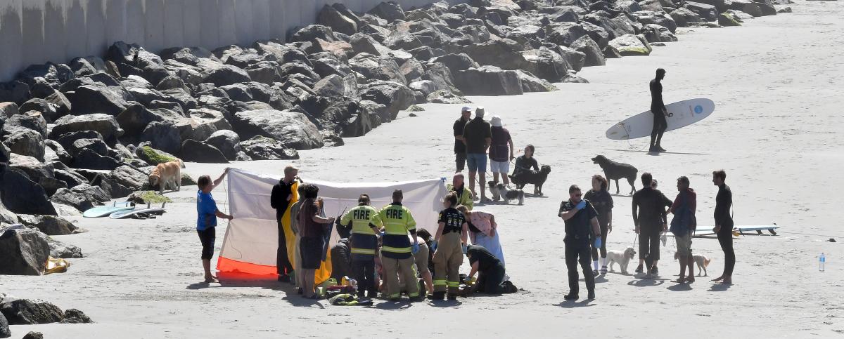 Surfer deeply upset as bid to save man fails