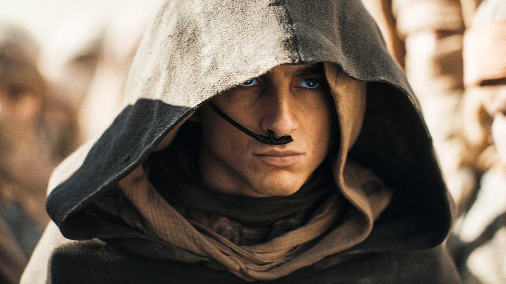 Paul Atreides looks angry while wearing a hood in Dune