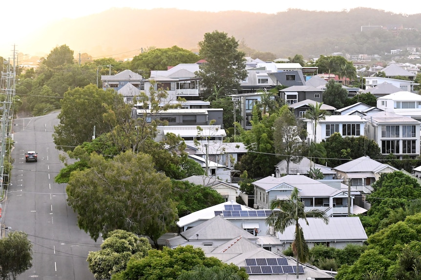 Residential houses on a hill at sunset.