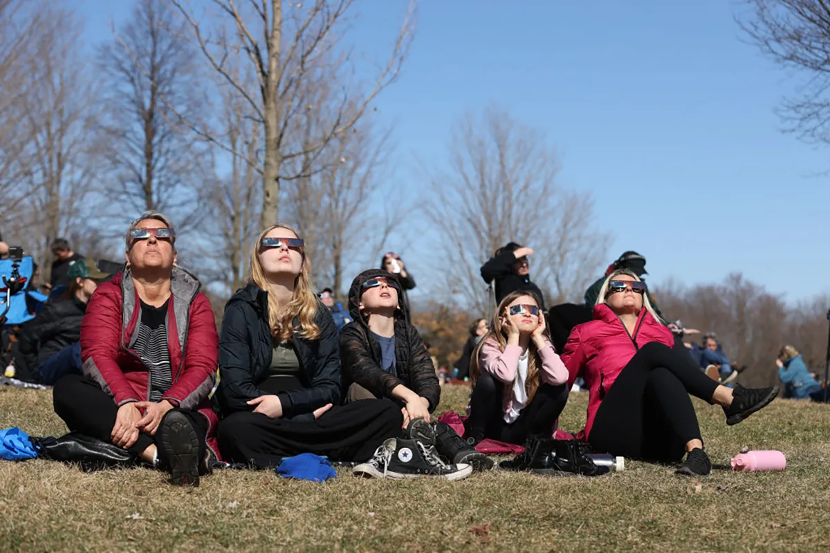 Eclipse chasers don eclipse glasses to see the April 8, 2024 total solar eclipse from Montreal, Quebec, Canada. Credit: Lokman Vural Elibol/Anadolu via Getty Images