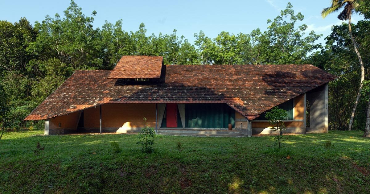 a semi-circular porous brick house stands amid rubber plantation in india