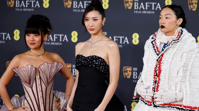 Rei Ami, EJAE and Audrey Nuna of 'KPop Demon Hunters' pose on the red carpet at the EE BAFTA Film Awards