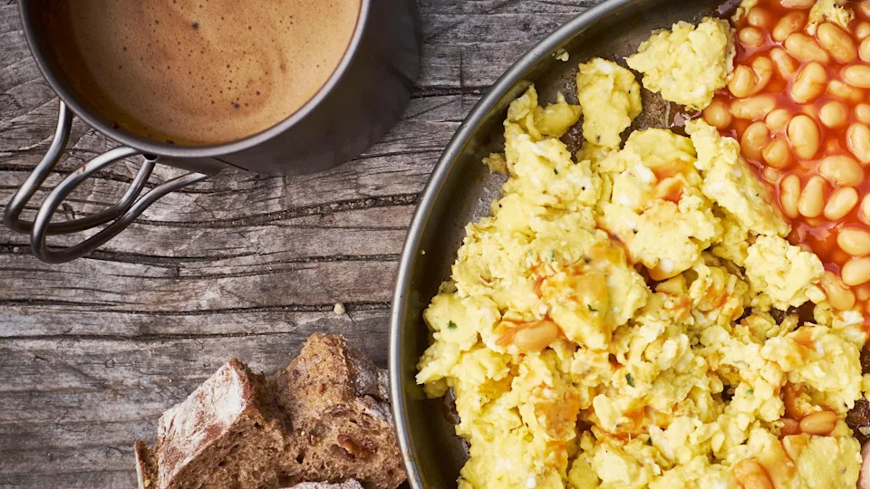 Breakfast with scrambled eggs, baked beans and bacon