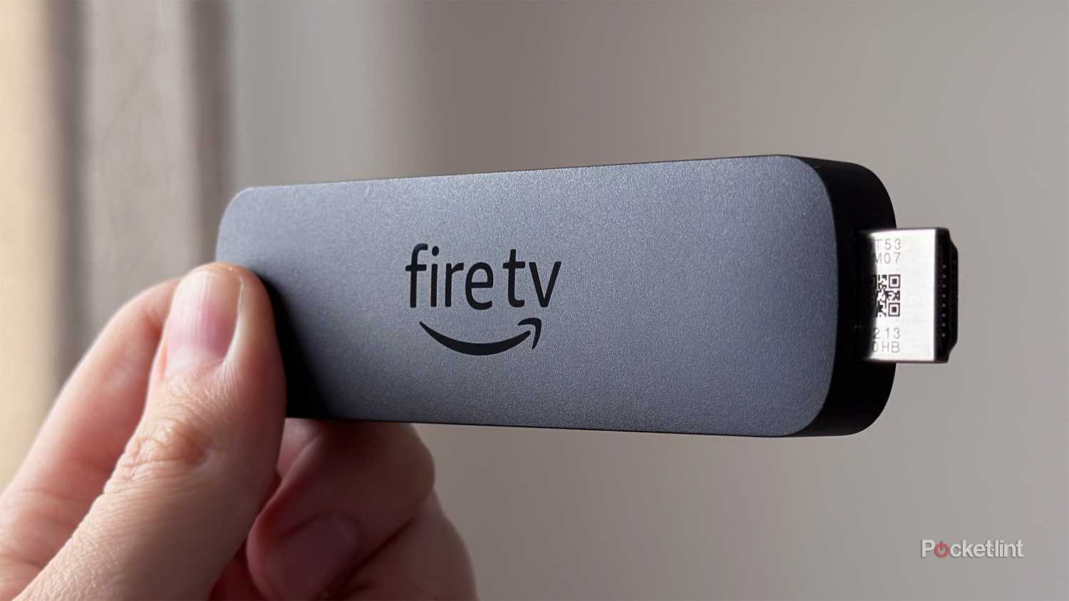 Person holding Fire TV Stick 4K Select.