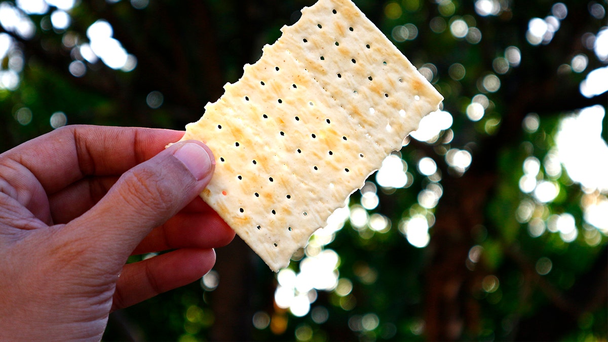 Man holding soda cracker