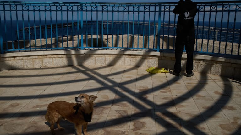 From a lookout, a man uses a binocular looking for the possible arrival of the US Navy's aircraft carrier USS Gerald R. Ford in the Mediterranean Sea near the coast of Haifa, northern Israel