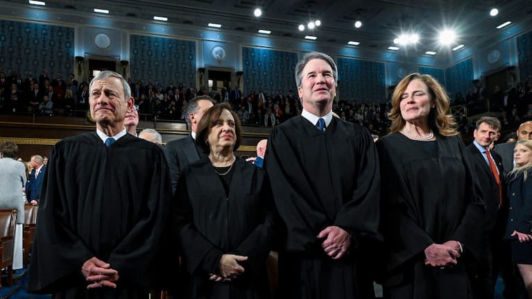 From left, Chief Justice John Roberts, Justice Elena Kagan, Justice Brett Kavanaugh and Justice Amy Coney Barrett stand before President Donald Trump delivers the State of the Union address to a joint session of Congress in the House chamber at the US Capitol in Washington. (Source: New York Times via AP)