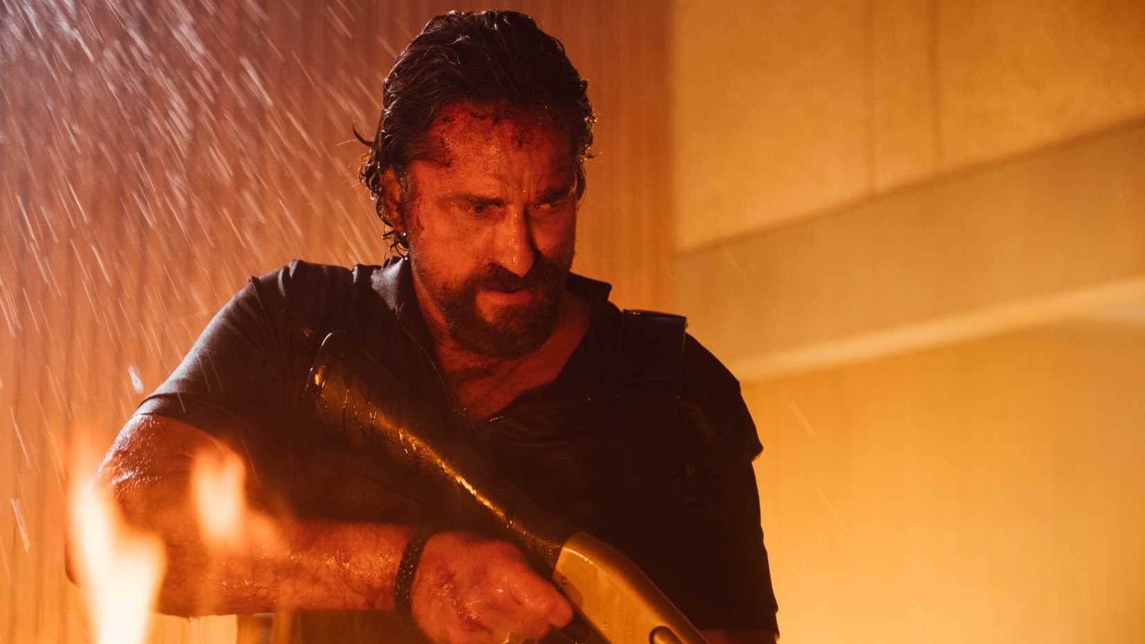 Gerard Butler holding a shotgun in Copshop