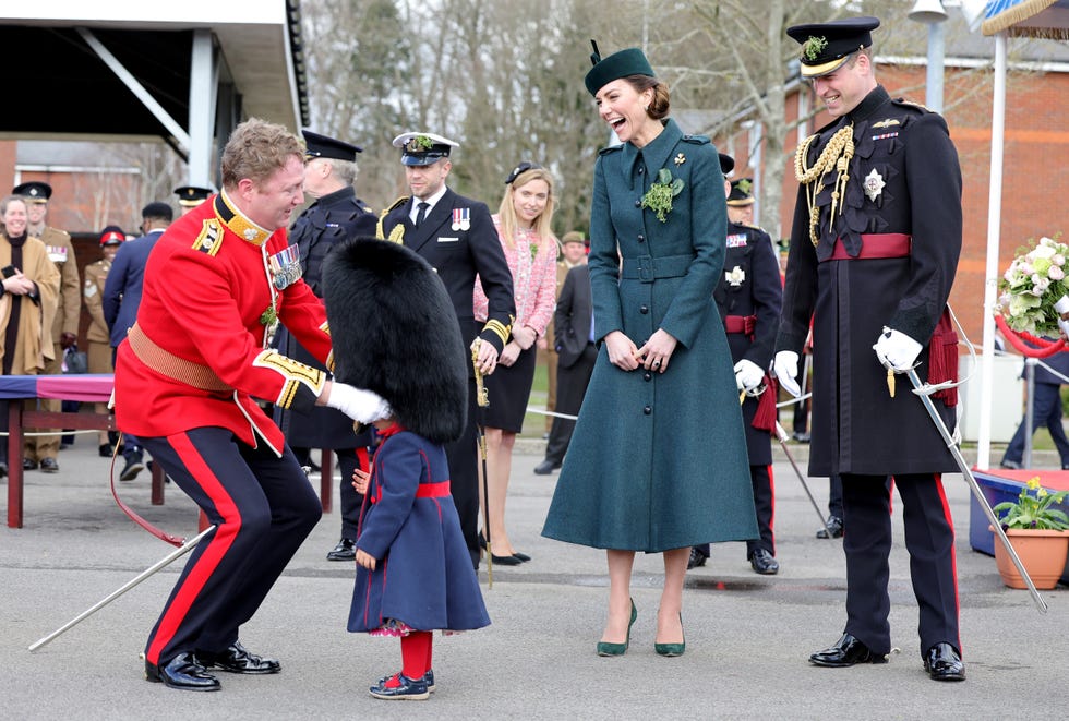 aldershot, england march 17: catherine, duchess of cambridge and prince william, duke of cambridge smile and laugh as lieutenant colonel rob money puts a bearskin hat on his 20 month old daughter gaia moneys head as they attend the 1st battalion irish guards st. patricks day parade at mons barracks on march 17, 2022 in aldershot, england. (photo by chris jackson wpa pool/getty images)