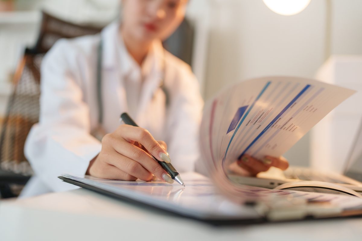 unidentified photo of a doctor writing up medical records