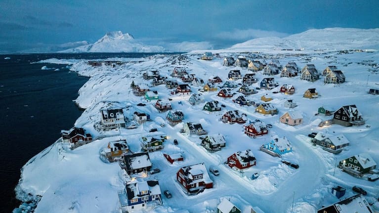 Houses covered in snow are seen on the coast of a sea inlet of Nuuk, Greenland, Friday, March 7, 2025.