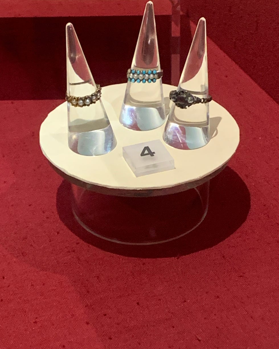 display of three decorative rings on stands