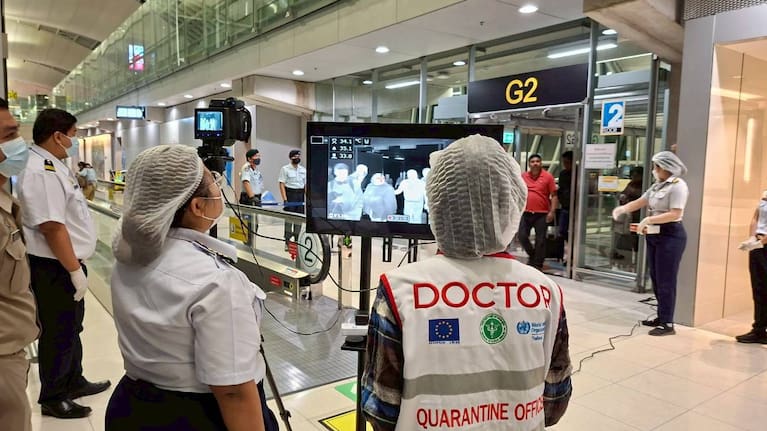 In this photograph provided by the public relations department of the Suvarnabhumi International Airport, Quarantine doctors watch thermal scanning of travelers from west Bengal, India at the Suvarnabhumi International Airport in Samut Prakarn, Thailand