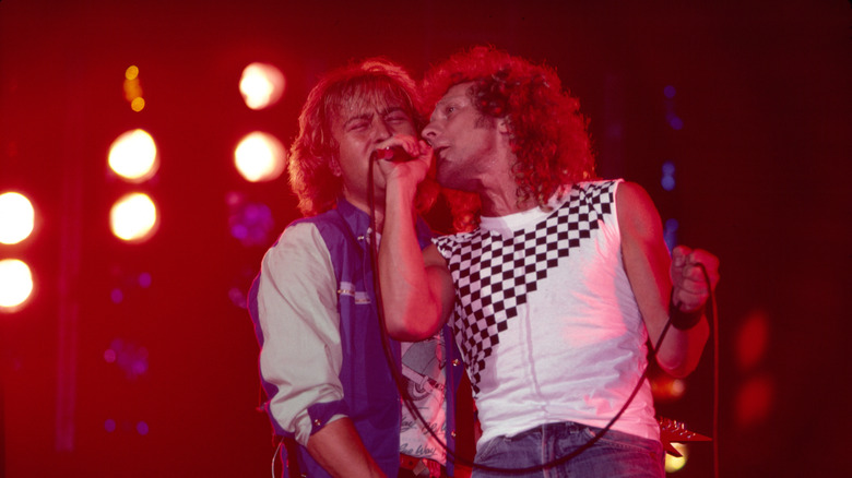 Mick Jones and Lou Gramm of Foreigner sing together on stage