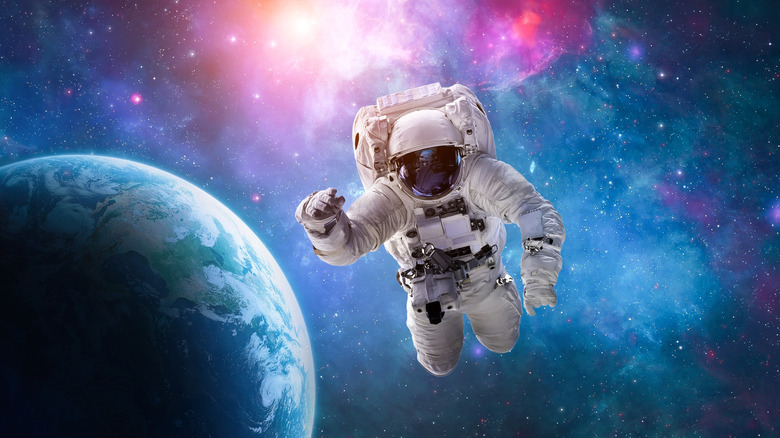 Astronaut in front of a bright space background with Earth visible in the lower corner