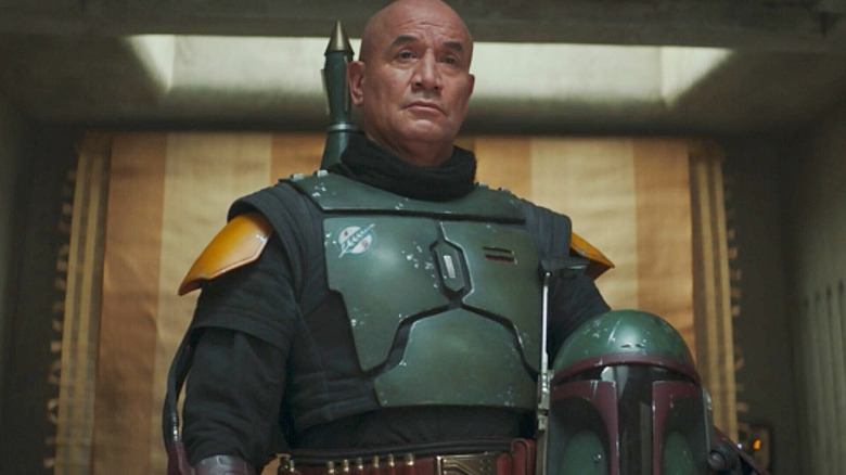 Temuera Morrison as Boba Fett holds his helmet in The Book of Boba Fett