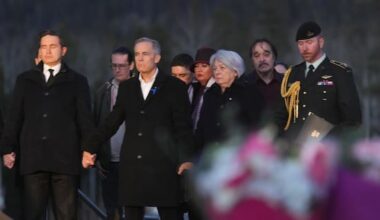 PM Carney and opposition leader hold hands at school shooting vigil