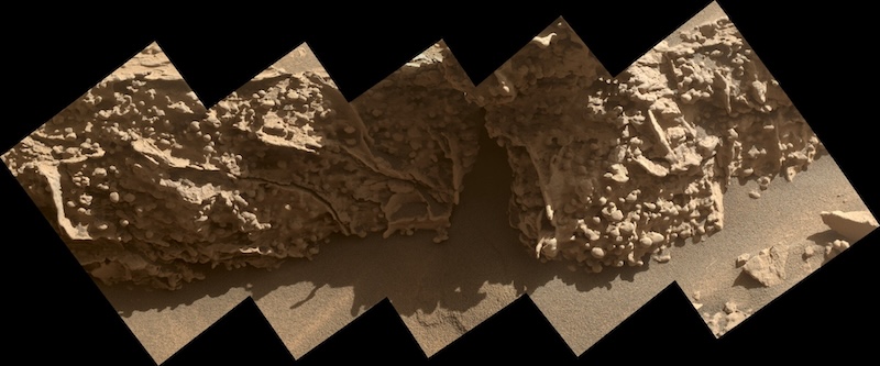 Side of a rock formation covered in small ridges and many small bulbous nodules.