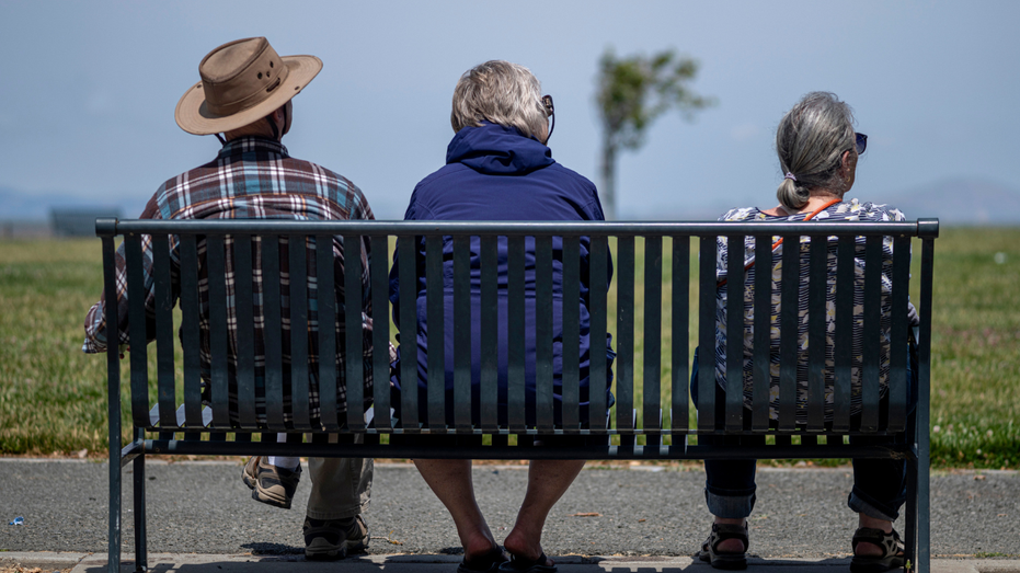 People sit on a bench in Hercules, California.