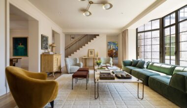 living room with white rug, yellow arm chair and green sofa