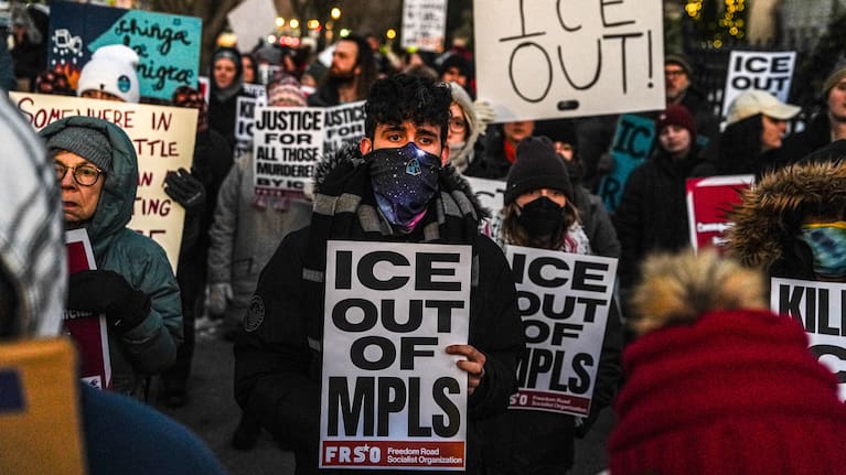 People participate in an anti-ICE protest outside of the Governors Residence in Minneapolis.