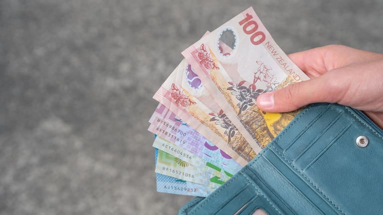 Person with Payout of New Zealand Dollars stock photo.