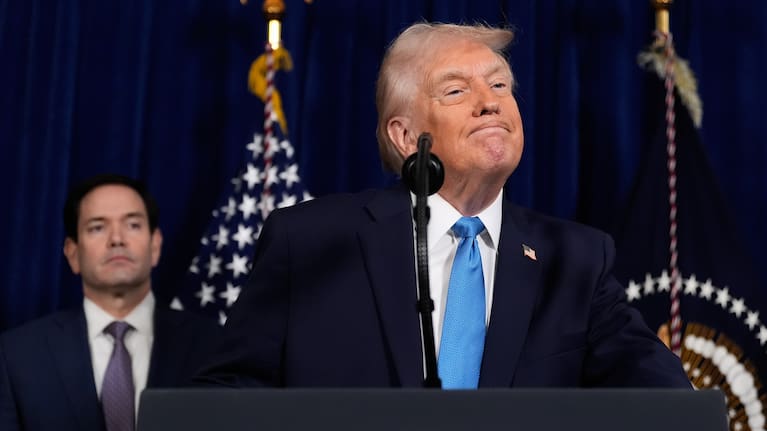 President Donald Trump listens to a question during a news conference at Mar-a-Lago, Saturday, Jan. 3, 2026, in Palm Beach, Fla., as Secretary of State Marco Rubio watches.