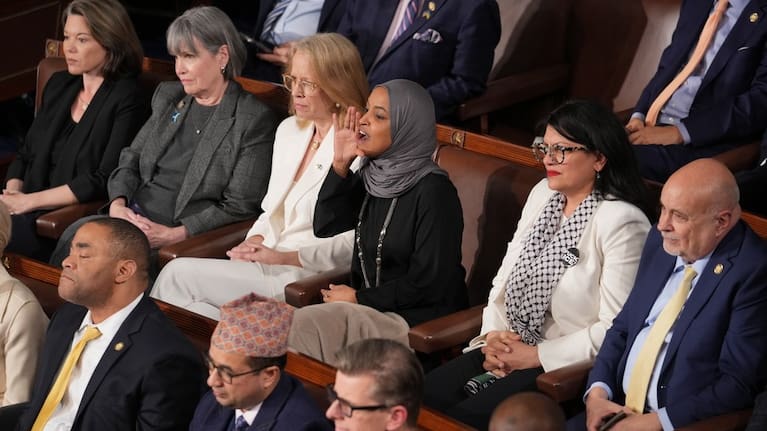Representative Ilhan Omar, D-Minn., centre, reacts as President Donald Trump gives his State of the Union address to a joint session of Congress.