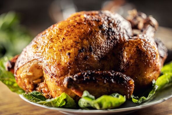 Roasted whole chicken on wooden cutting board. Roasted whole chicken on wooden cutting board.