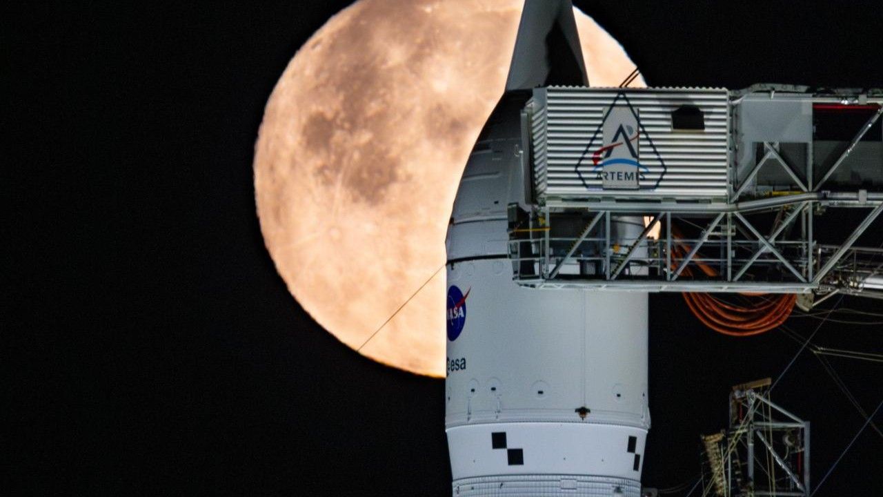 NASA's Artemis 2 moon rocket in front of a full moon