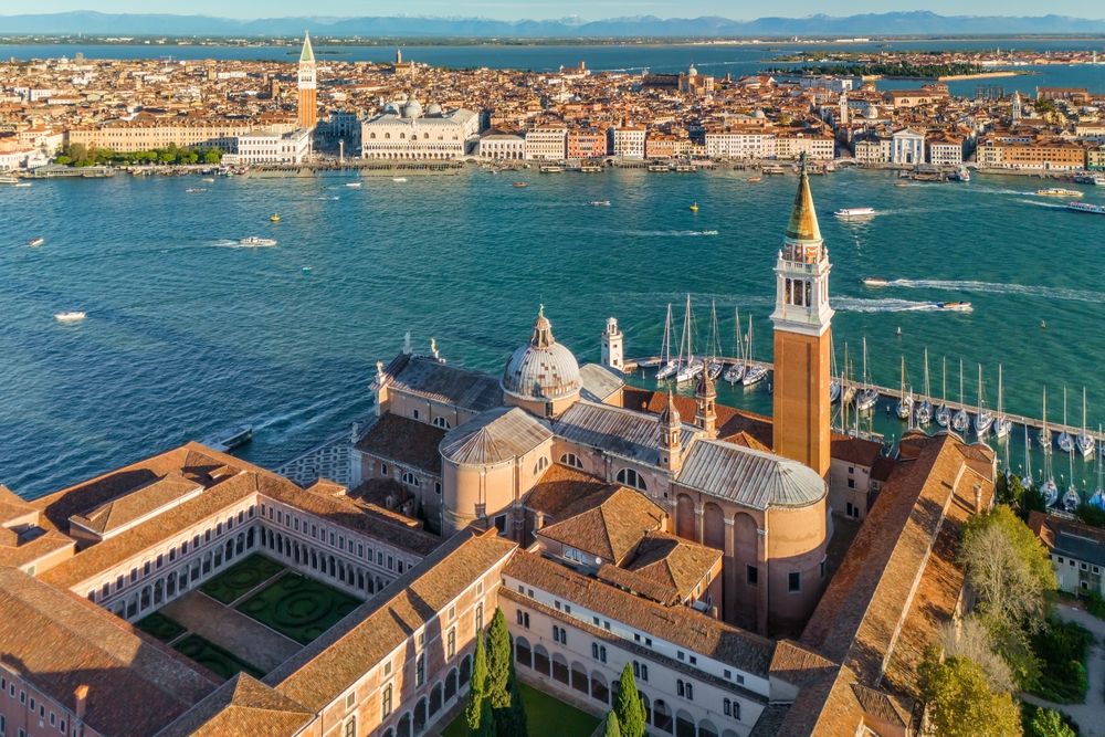 Aerial view of the Venetian lagoon showing San Giorgio Maggiore island and Grand Canal in Venice, Italy, at sunrise,