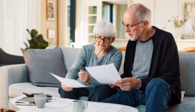 I’m 61. My wife and I have $1M saved and will get $14K a month in pensions. We own 3 homes — but won’t pay them off for 28 years. Can I retire next year?