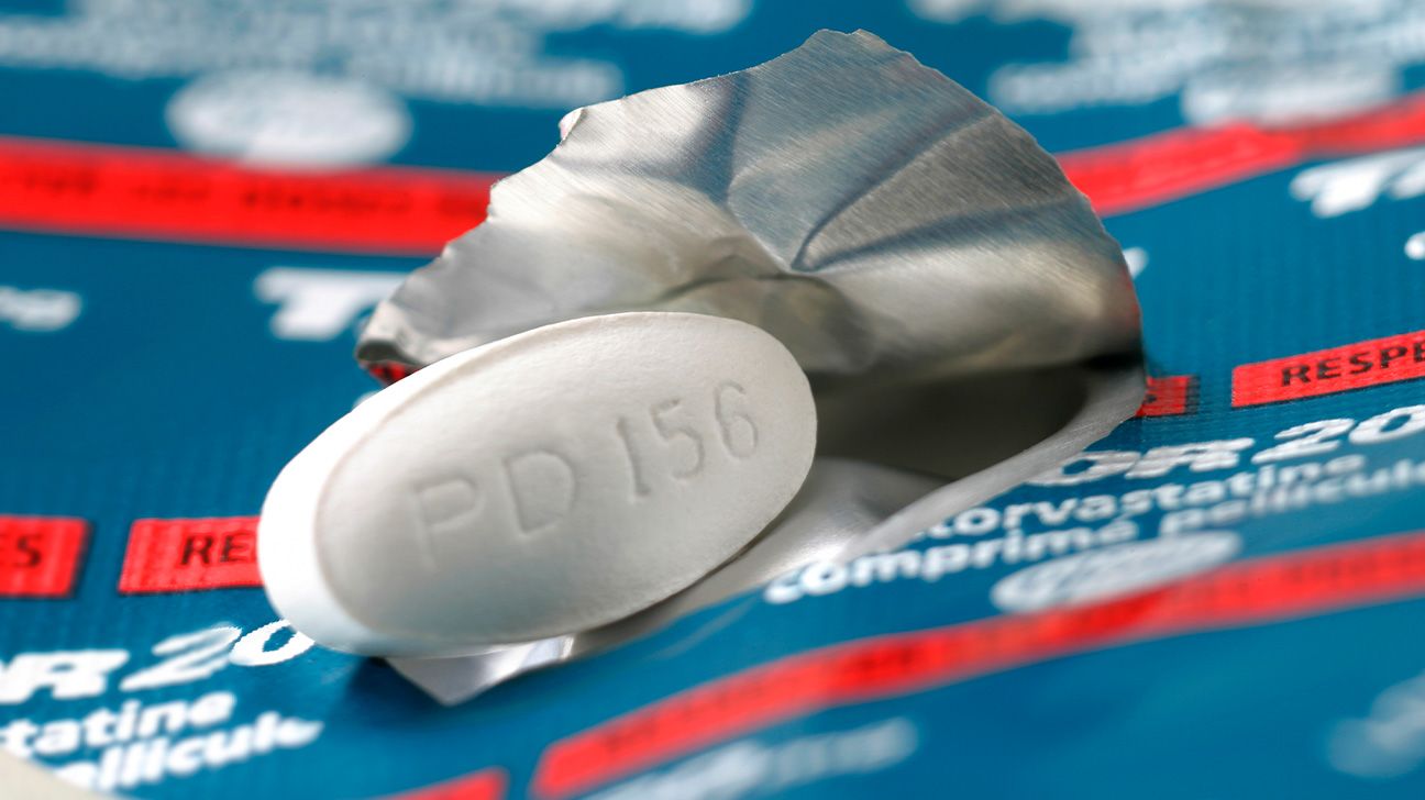 Statin pill lying on top of a blister pack