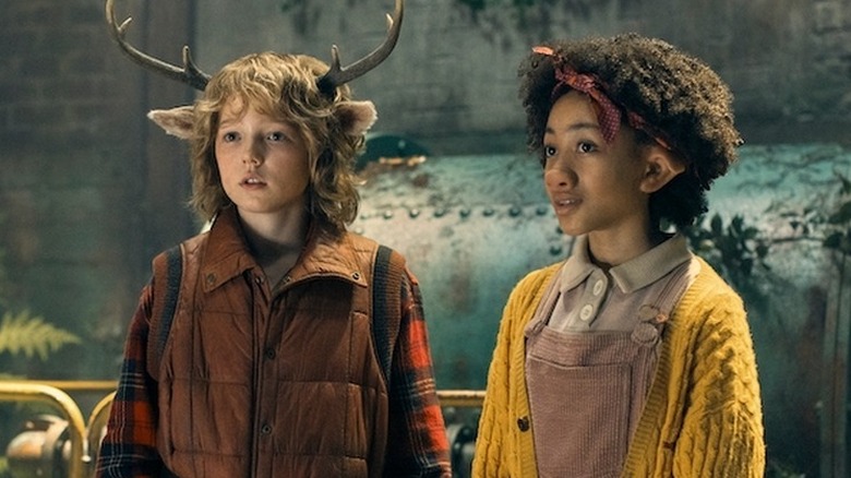 A young boy named Gus with deer antlers and his friend Wendy, who has a pig nose, in Sweet Tooth