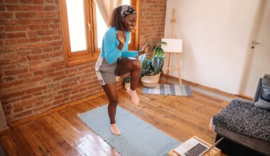 woman does a walking workout at home in front of her laptop