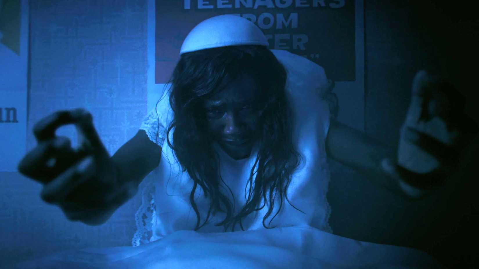 Tenika Davis as Ida Grogan looking sadly with her arms extended in IT: Welcome to Derry season 1