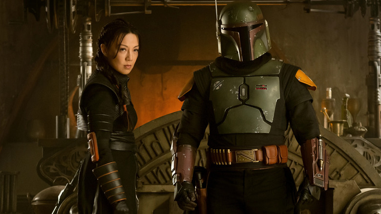 Ming-Na Wen as Fennec Shand stands next to Temuera Morrison as Boba Fett in The Book of Boba Fett