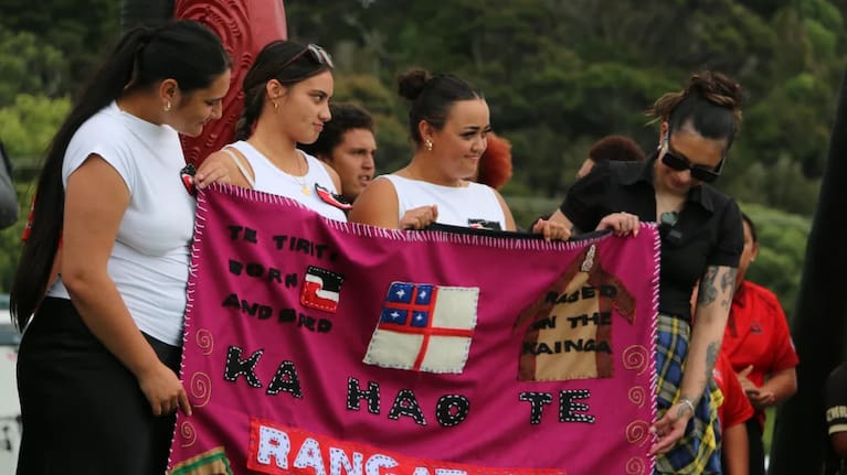 Three kōtiro gift rangatahi MP Tamatha Paul a paraikete (blanket) inscribed with the kupu ‘Ka hao te rangatahi’ – a message that the next generation will take up the work and responsibility.
