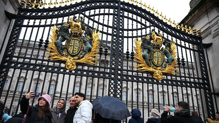 Tourists are seen outside Buckingham Palace on the day Britain's former prince Andrew was arrested on suspicion of misconduct.