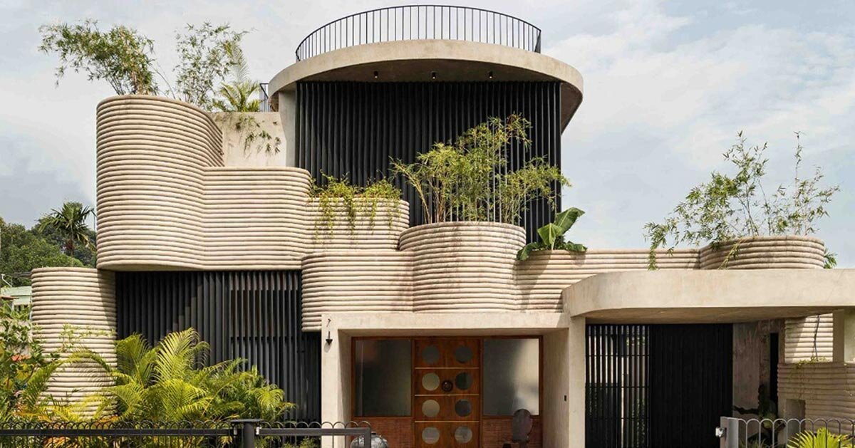 circular green terraces carve through exposed concrete facade in india