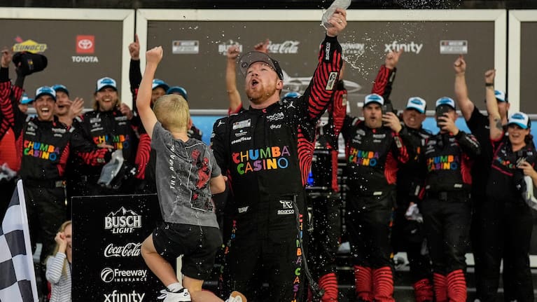 Tyler Reddick, (45) and his son Beau celebrate with the team after winning the NASCAR Daytona 500 auto race at Daytona International Speedway