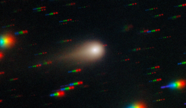 A blurry white, hazy circle surrounded by rainbow streaks.