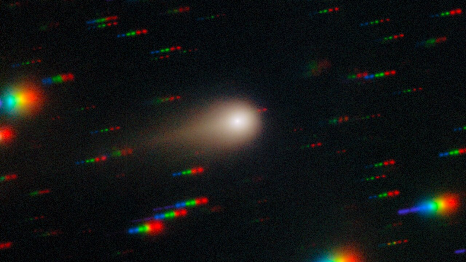 A blurry white, hazy circle surrounded by rainbow streaks.