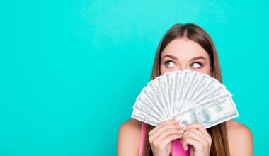 A person look out above a fanned stack of money.