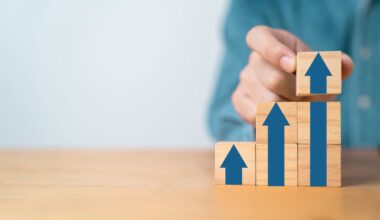 A person arranges building blocks to show increasingly large arrows that point up.