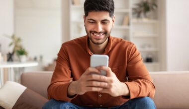 An investor looks at something on a smartphone at home.