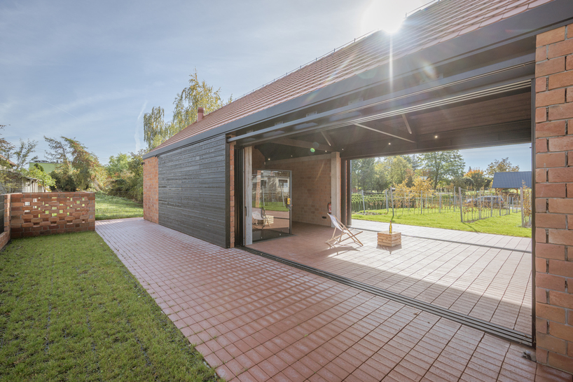 barrel-vaulted concrete cellar organizes vineyard building in poland